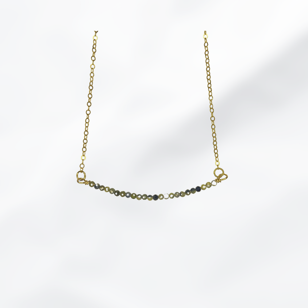 Crisilyne’s sapphire beaded bar necklace is the perfect way to add a touch of elegance to your outfit.