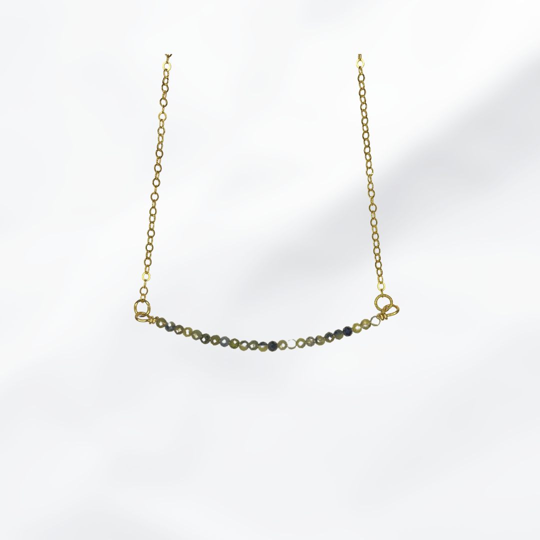Crisilyne’s sapphire beaded bar necklace is the perfect way to add a touch of elegance to your outfit.